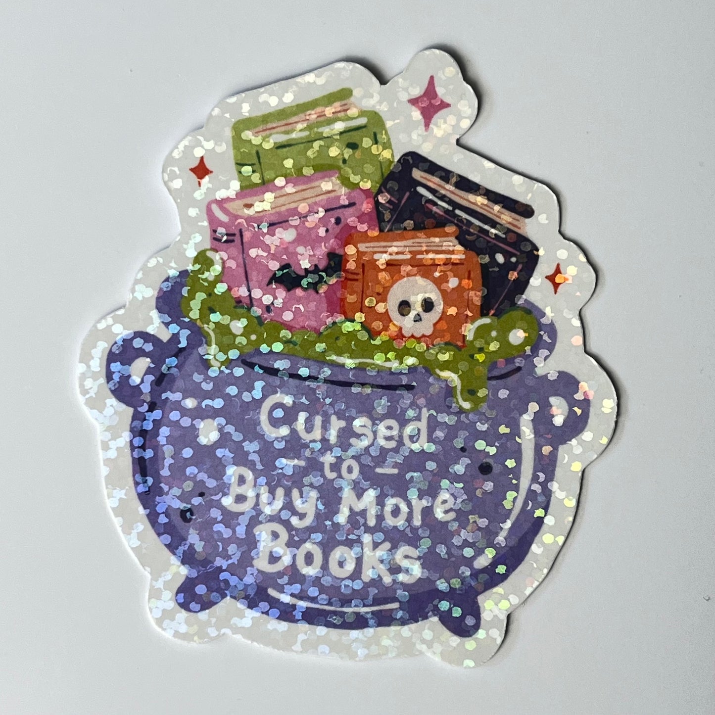 Naklejka Odklejka z serii SPOOKY DELULU  -  CURSED TO BUY MORE BOOKS